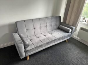 New condition three seater sofa bed in Grey colour